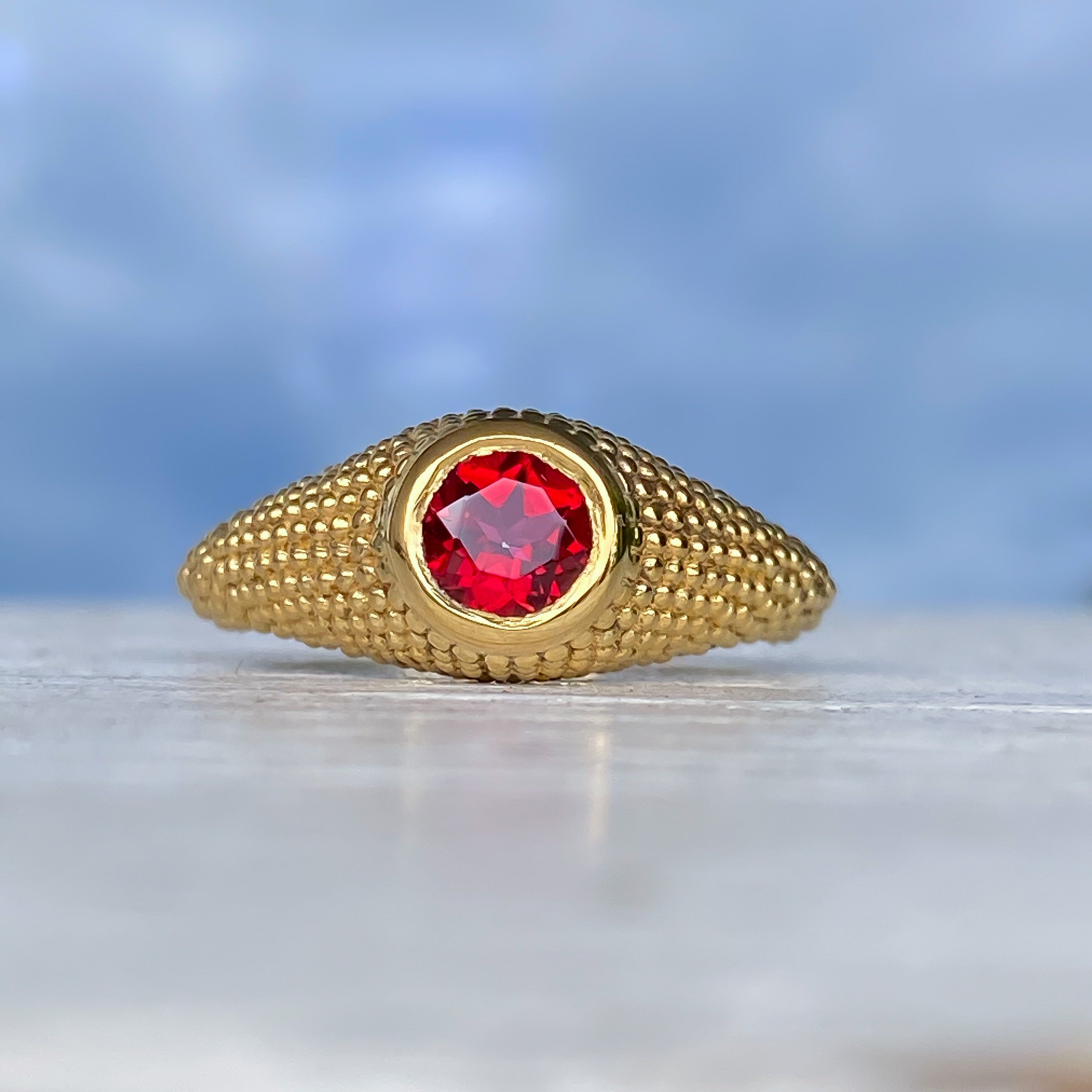 Bague Nubia en or jaune et topaze rouge ronde, taille 7,5 US